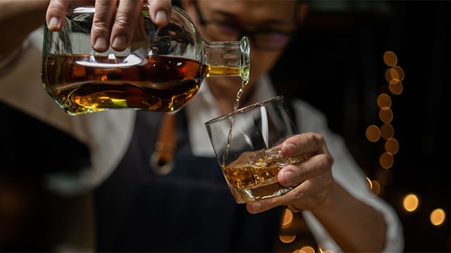 man-pouring-whiskey